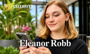 "Eleanor Robb smiling while using a smartphone outdoors in a high-quality professional portrait with a blurred green background."